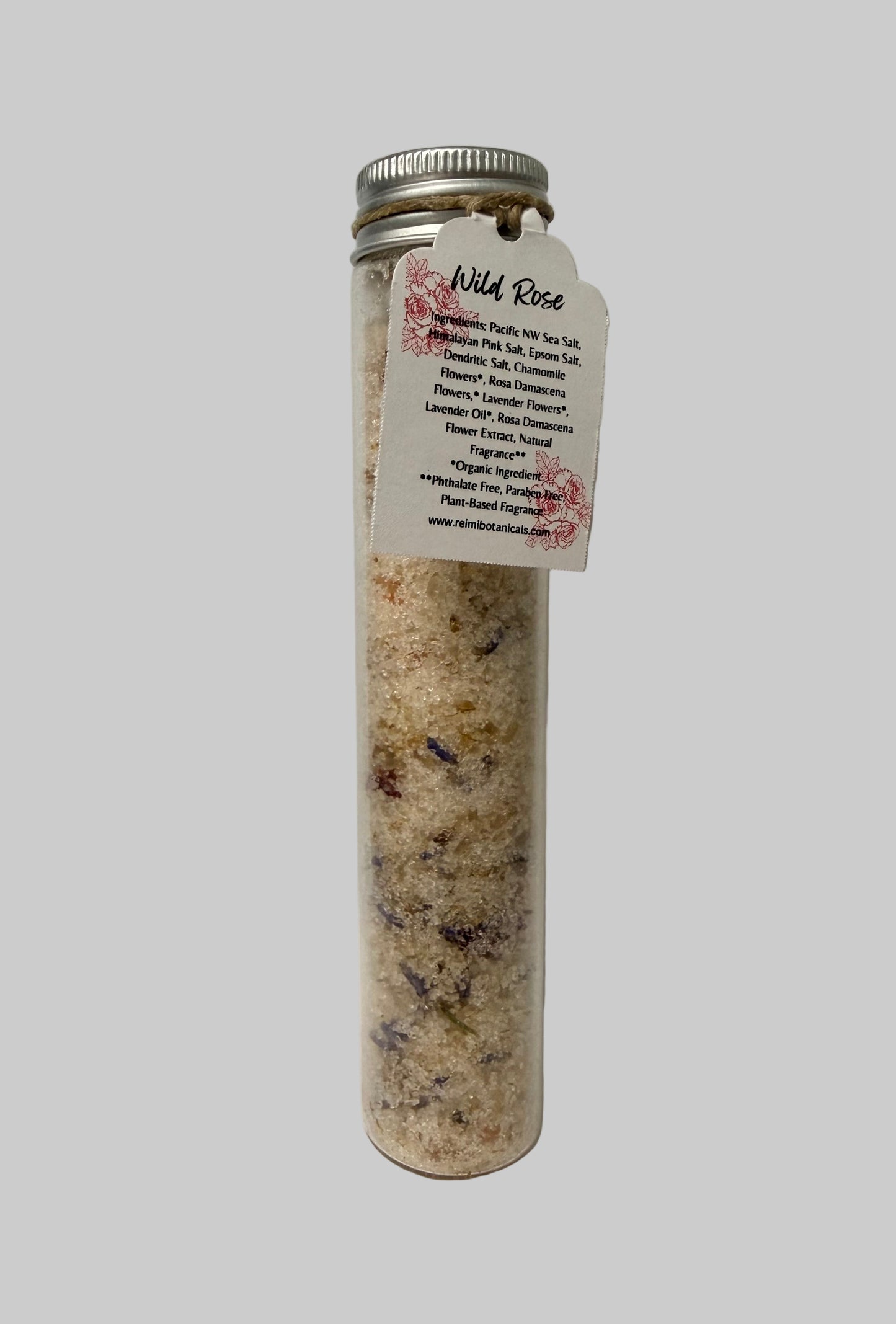 Tube of Wild Rose bath salts with a label on a white background