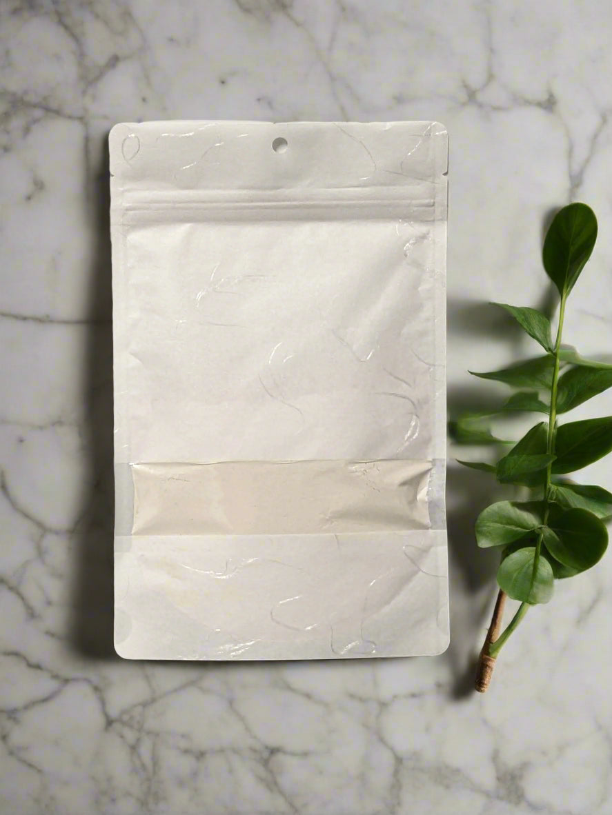 compostable white pouch with face cleansing powder inside