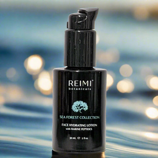 A black pump bottle of REIMMI BOTANICALS SEA FOREST COLLECTION Face Hydrating Lotion with Marine Plant Peptides, displayed on a marble surface.
