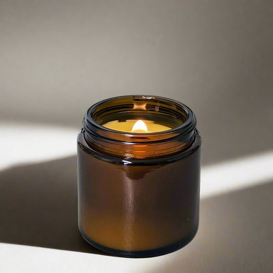 candle in amber glass vessel with wooden wick flame