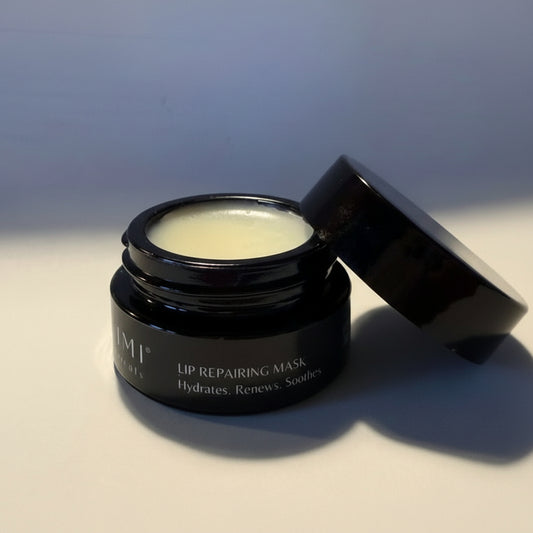 Black lip repairing mask jar with open lid on a light surface