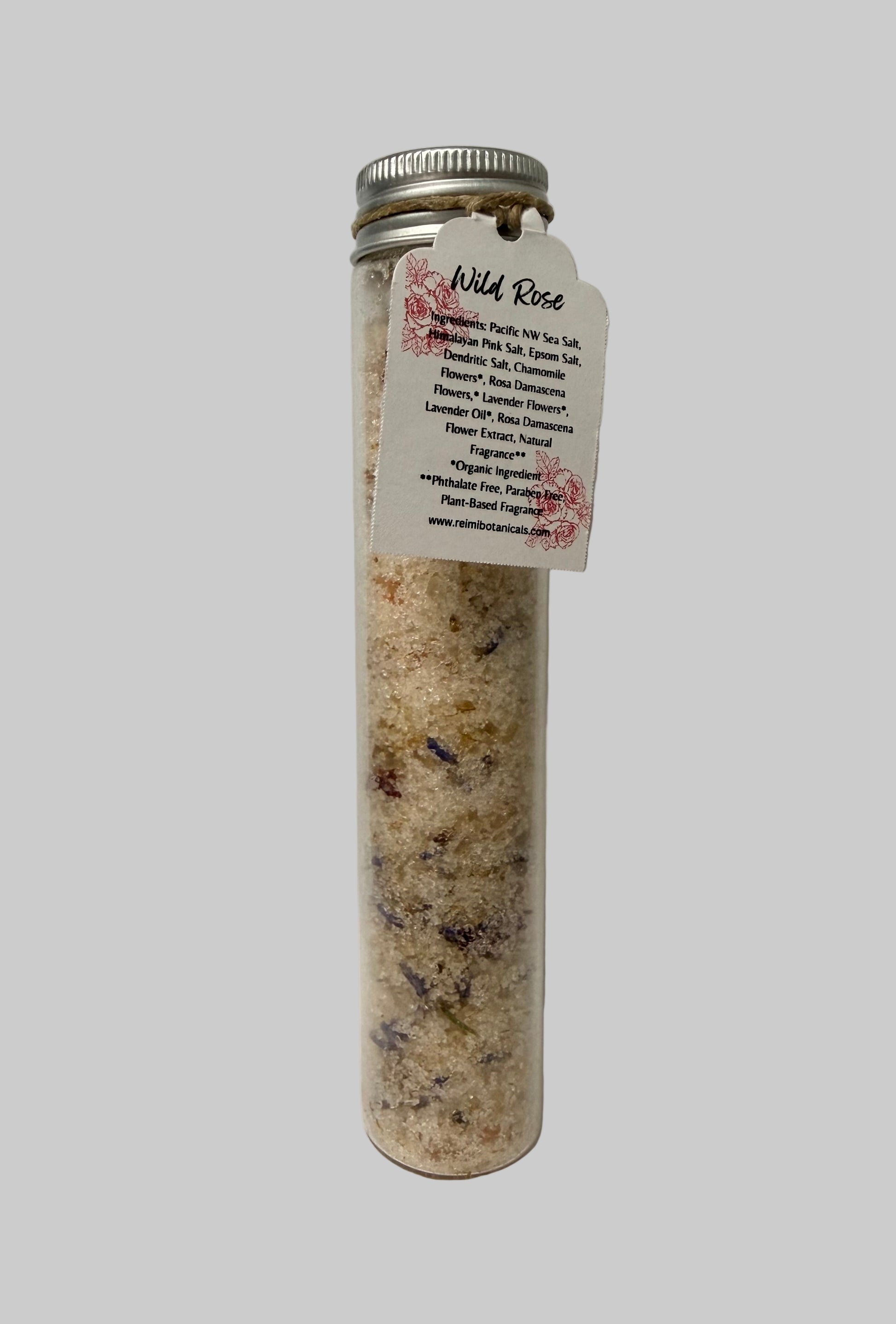 Tube of Wild Rose bath salts with a label on a white background