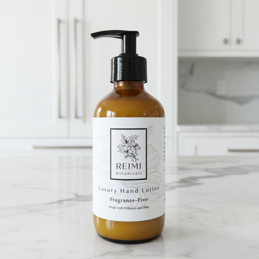 brown glass bottle of REIMI lotion on a white marble countertop