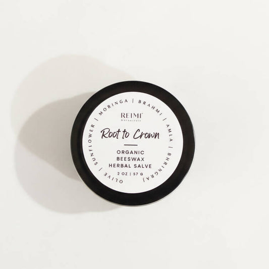 Round container of organic beeswax herbal salve with 'REIMI' branding on a white background